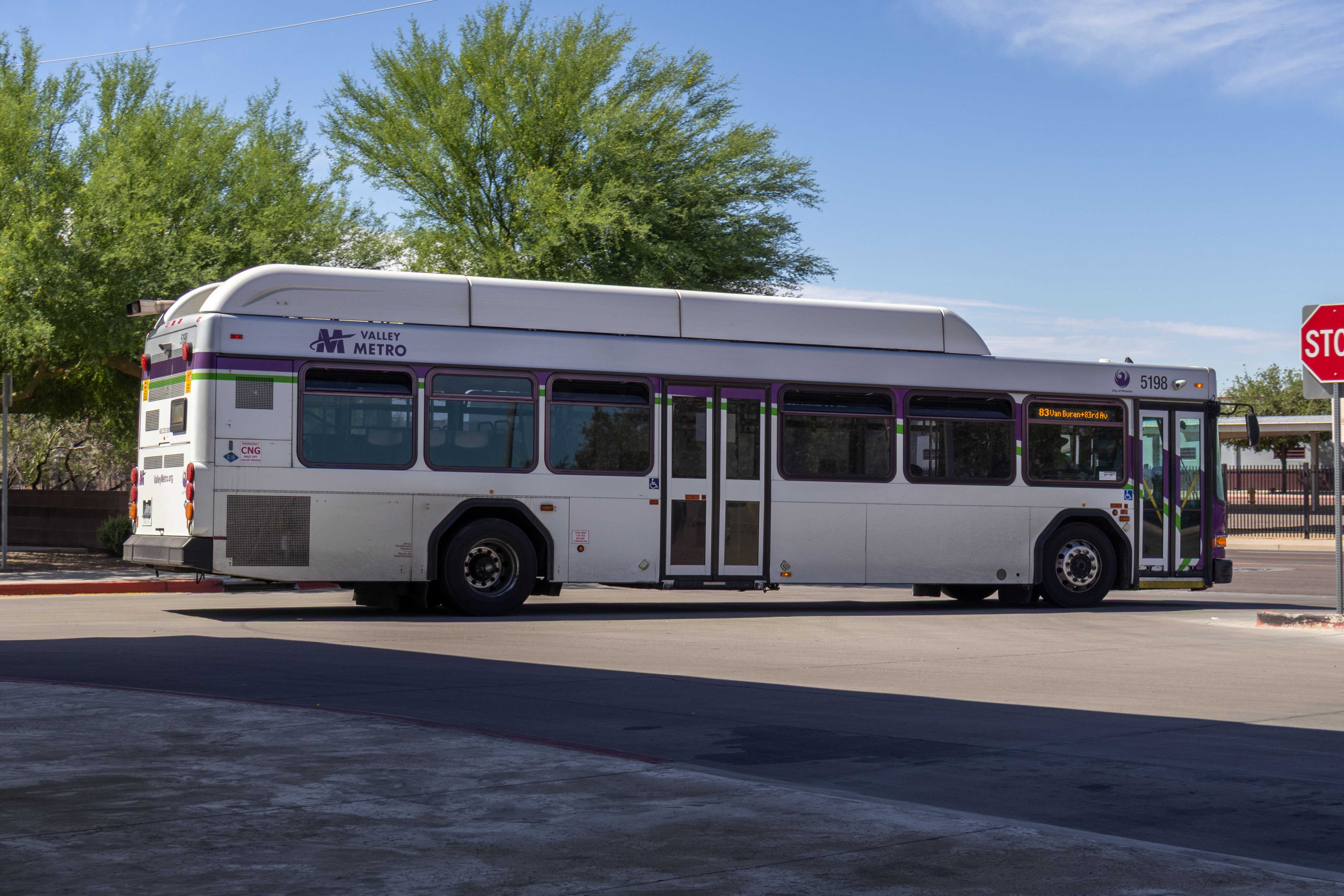 A white and gray Valley Metro bus, with purple and green accent colors, number 5198, at Desert Sky Transit Center in Phoenix on route 83 to 83rd Avenue and Van Buren Street