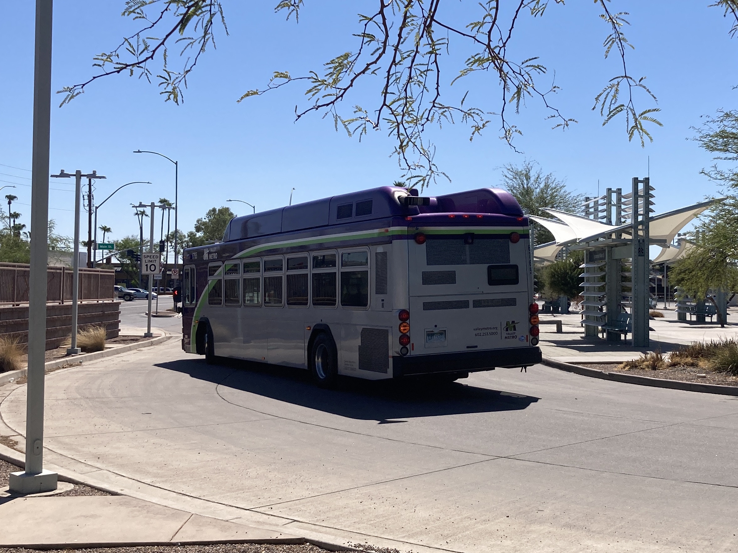 A gray and purple Valley Metro bus with a white and green stripe, number 6765, at Sycamore / Main Street Transit Center in Mesa on route 96 to Mesa Riverview