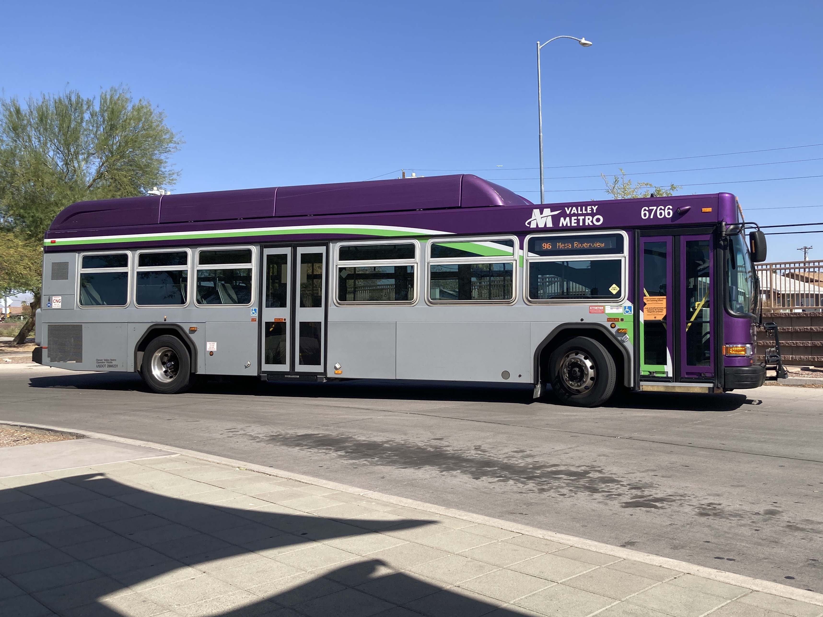 A gray and purple Valley Metro bus with a white and green stripe, number 6766, at Sycamore / Main Street Transit Center in Mesa on route 96 to Mesa Riverview