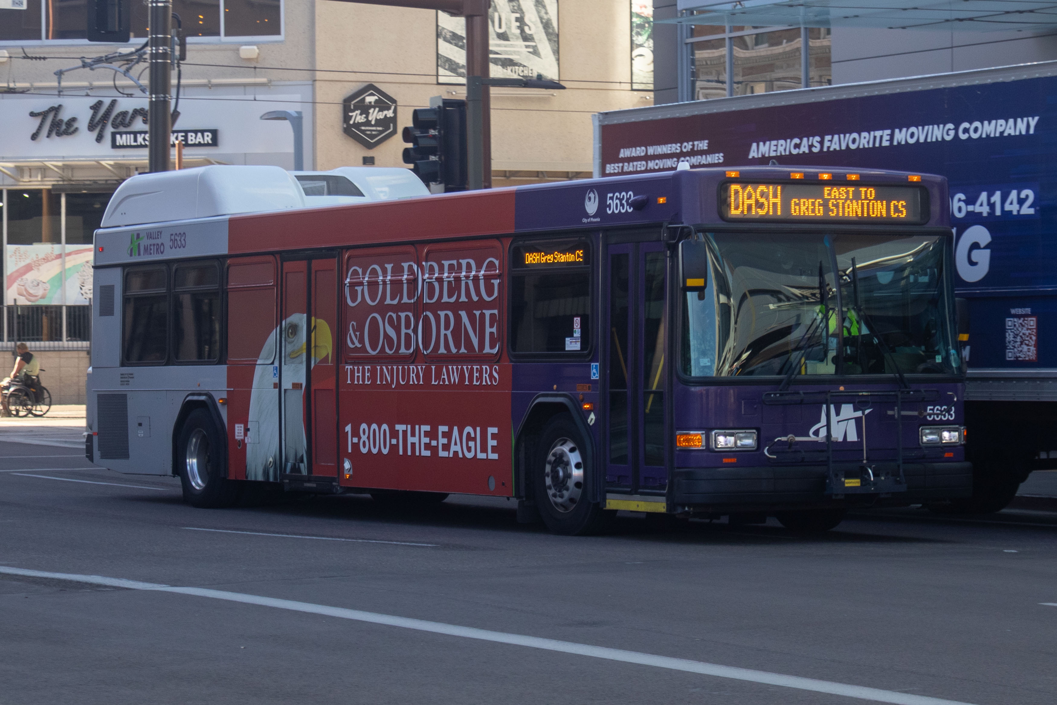 A purple and gray Valley Metro bus, number 5633, traveling eastbound on Jefferson Street in Phoenix on the DASH route to Greg Stanton Central Station