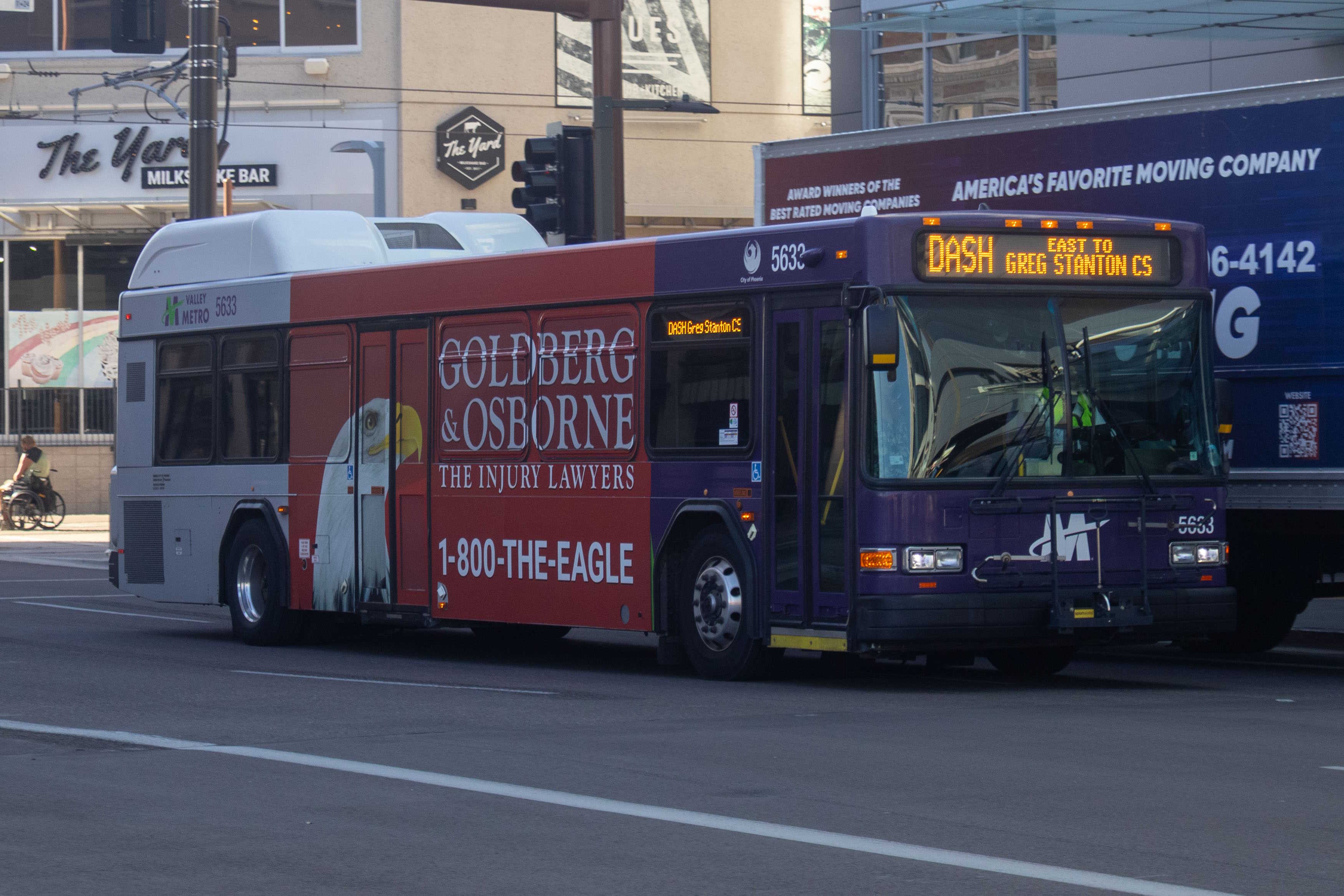 A purple and gray Valley Metro bus, number 5633, traveling eastbound on Jefferson Street in Phoenix on the DASH route to Greg Stanton Central Station