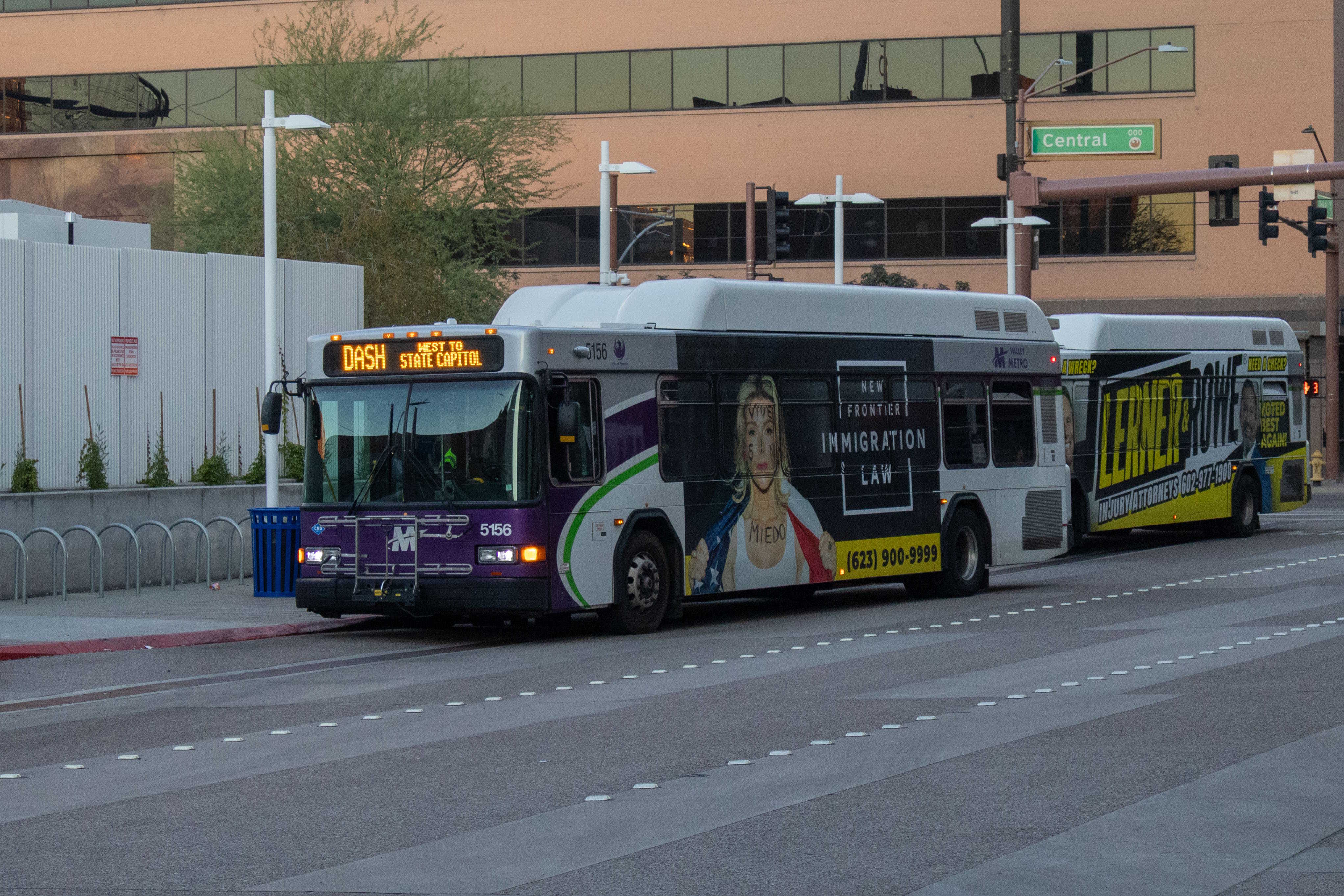 A white and gray Valley Metro bus, with purple and green accent colors, number 5156, at Greg Stanton Central Station in Phoenix on the DASH route to State Capitol