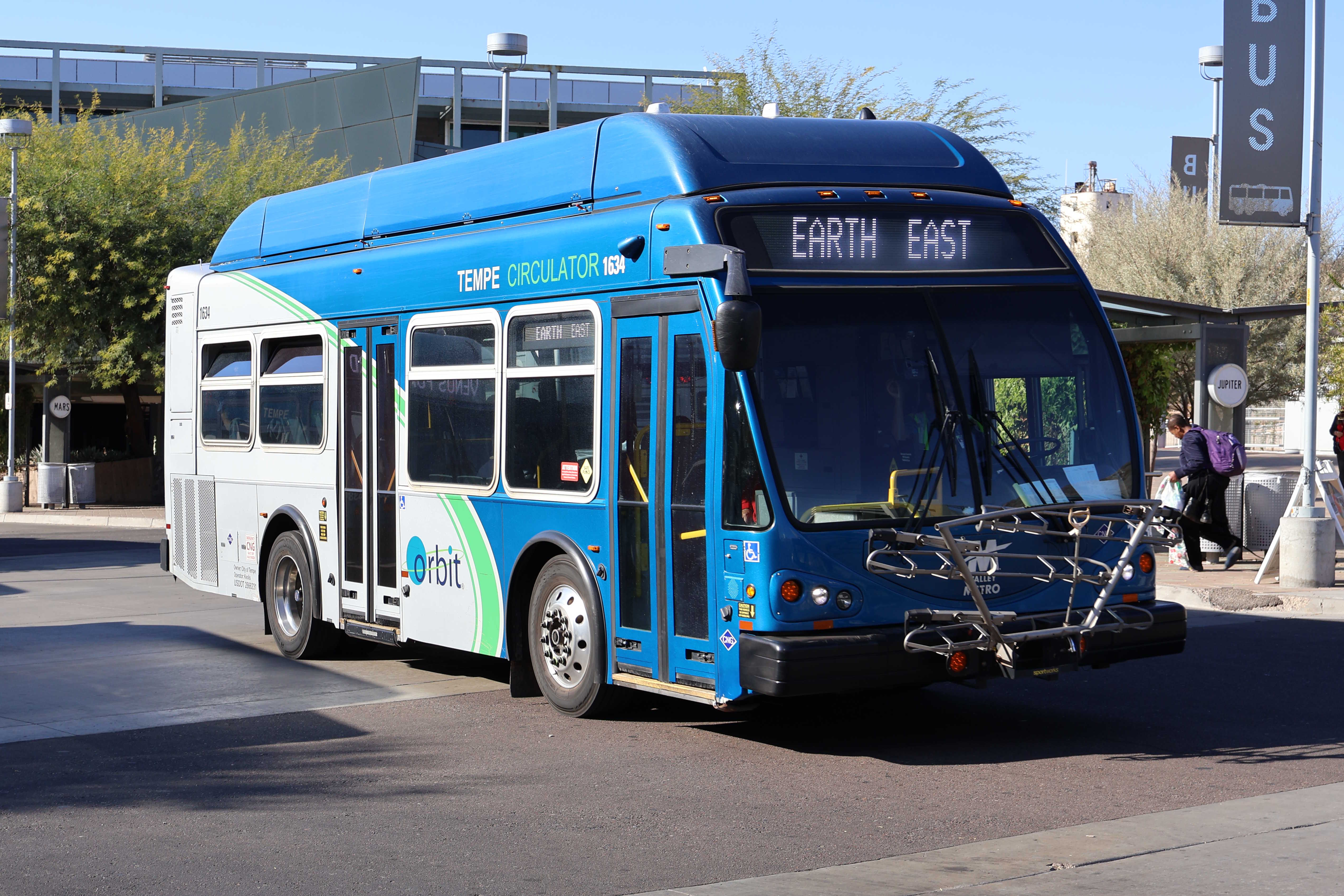 A gray and blue Orbit bus, with a green stripe, number 1634, at Tempe Transportation Center on the Earth route to Tempe Marketplace