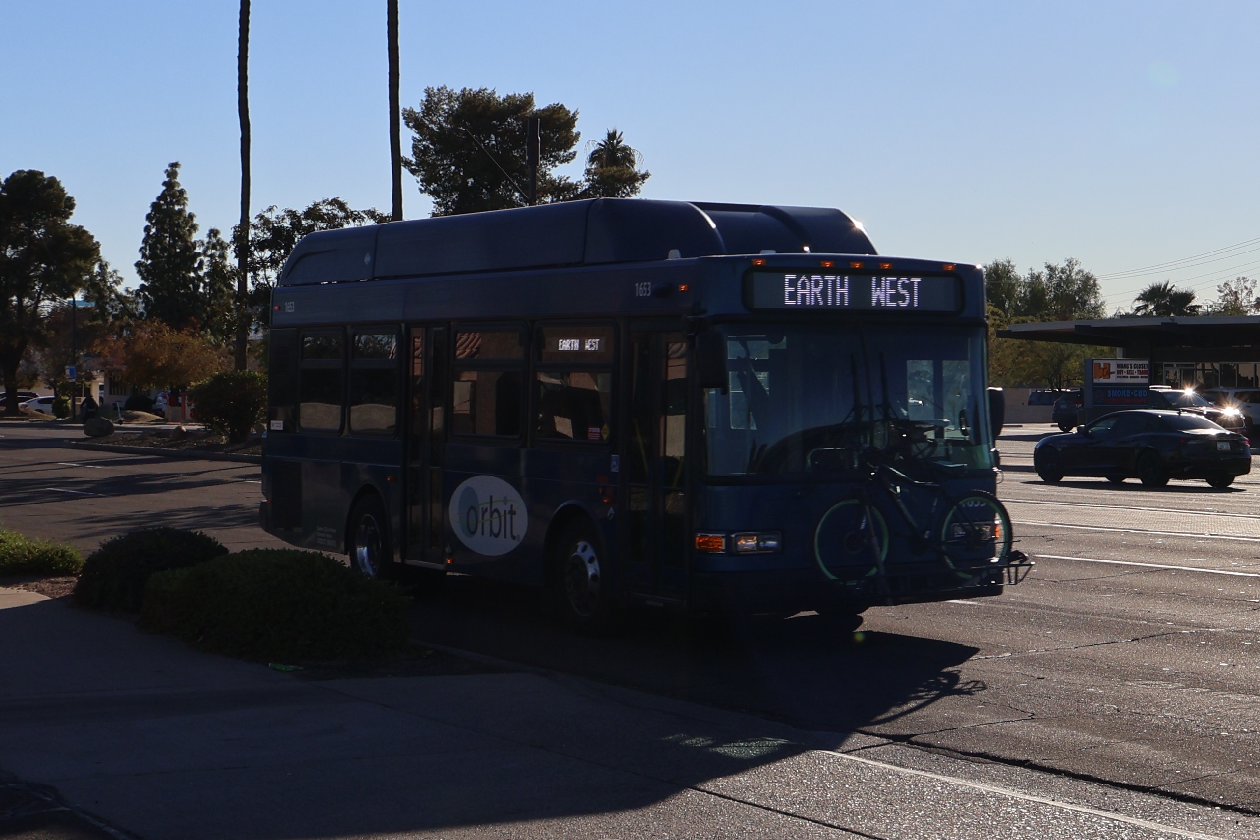 A blue Orbit bus, number 1653, traveling northbound on Scottsdale Road on the Earth route to Tempe Transportation Center