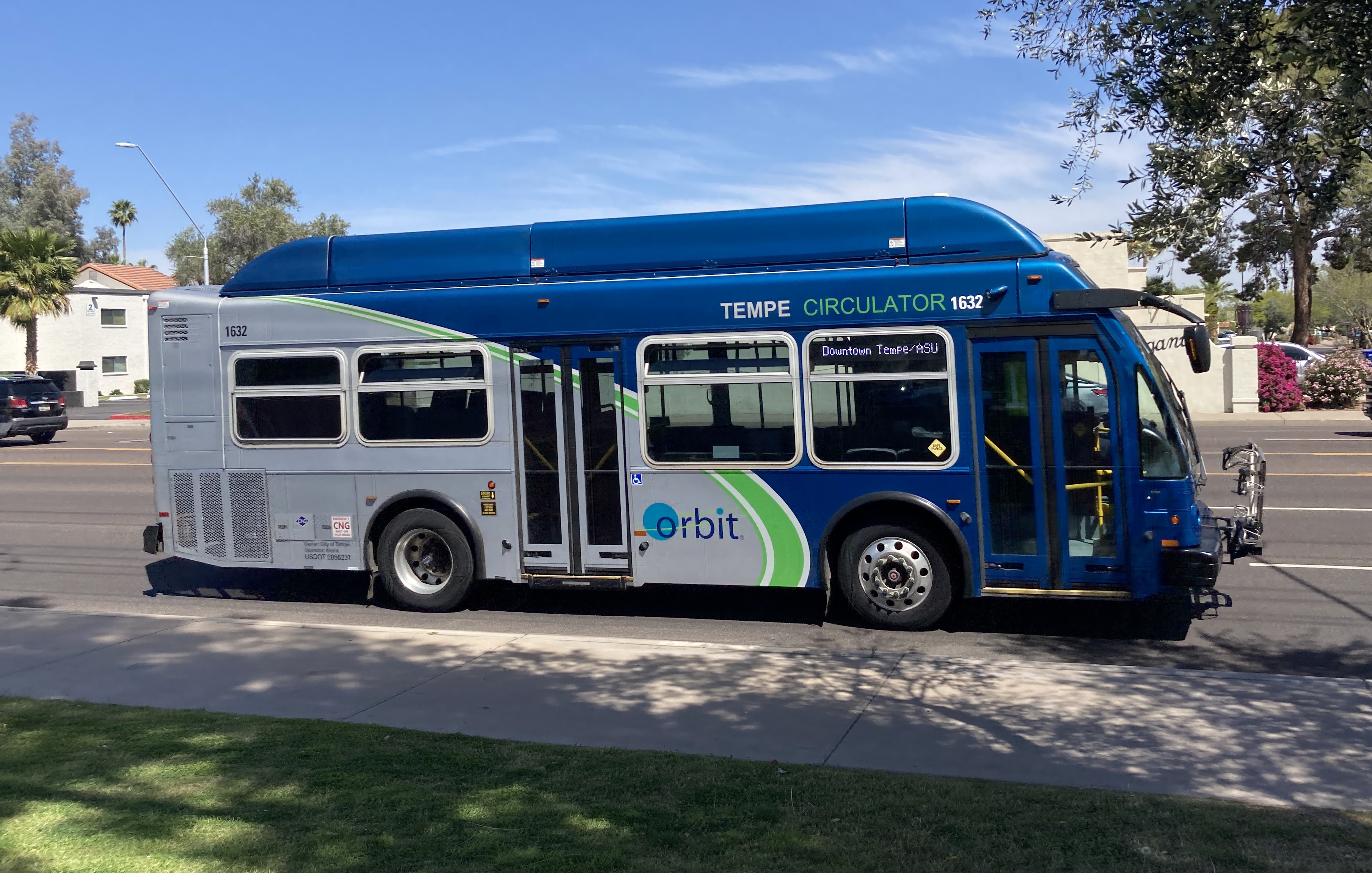 A gray and blue Orbit bus, with a green stripe, number 1632, traveling southbound on Rural Road on the Jupiter route to Tempe Transportation Center