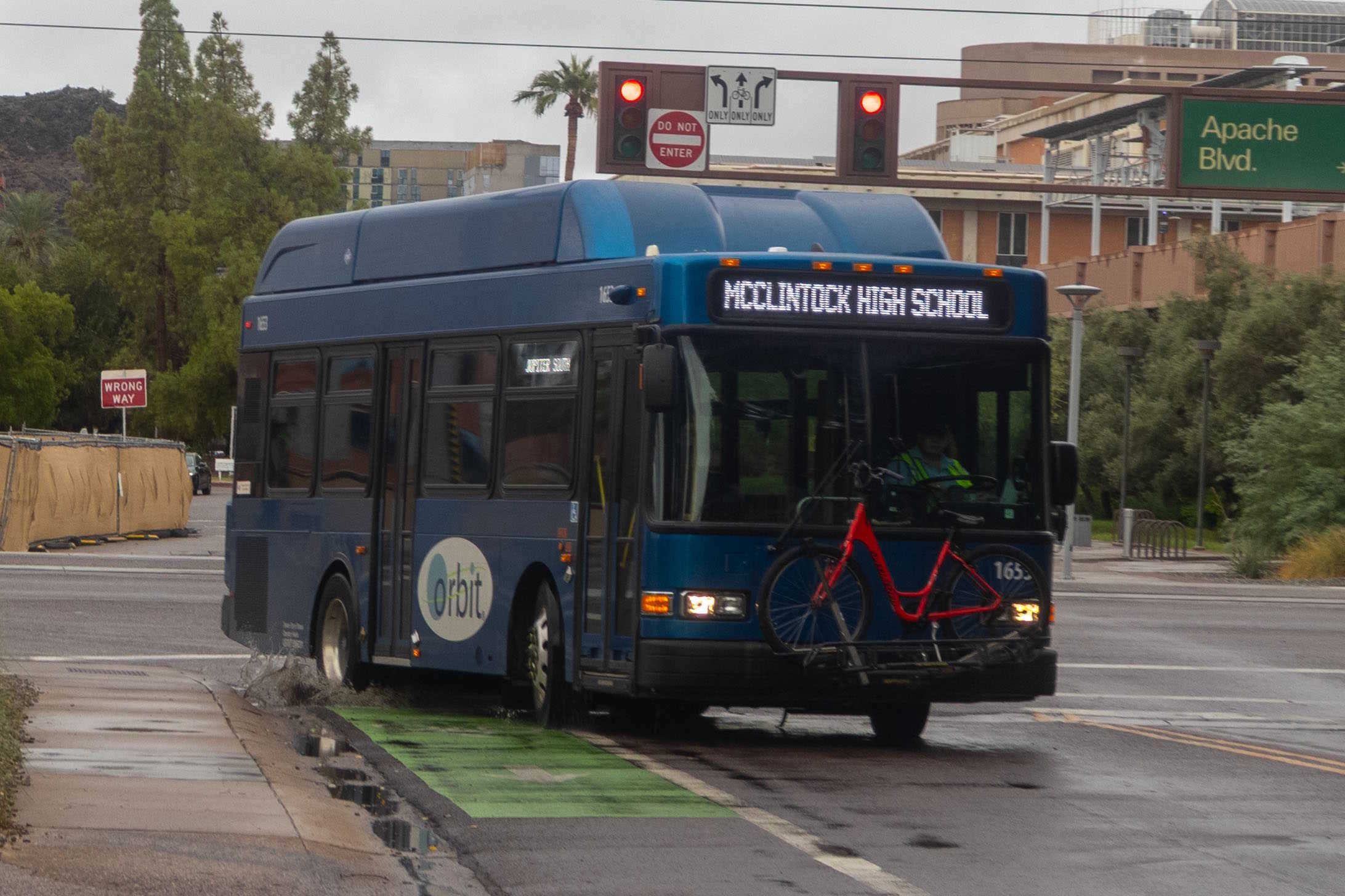A blue Orbit bus, number 1653, traveling southbound on College Avenue on the Jupiter route to McClintock High School