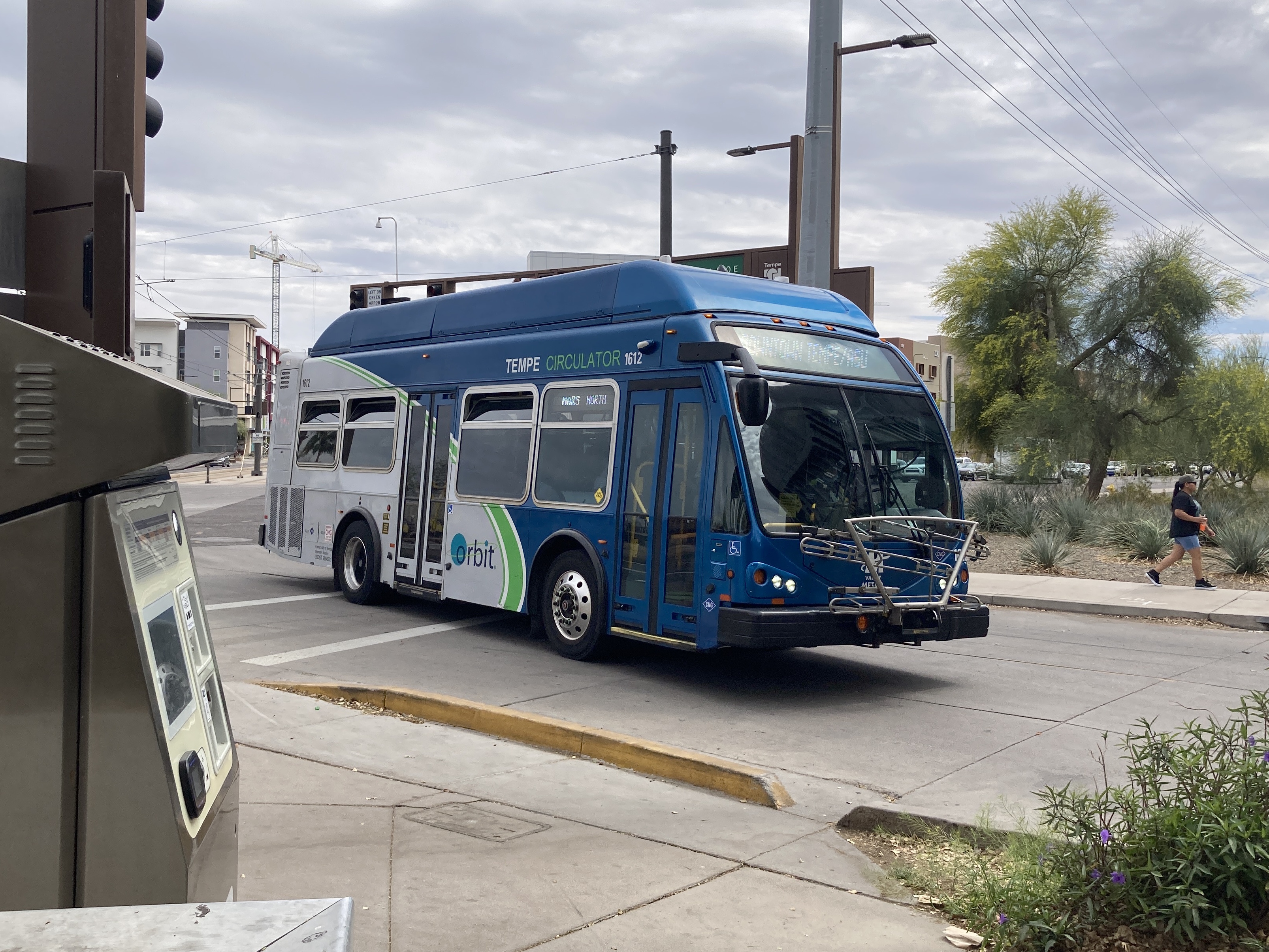 A gray and blue Orbit bus, with a green stripe, number 1612, at the University and Rural Transit Center on the Mars route to Tempe Transportation Center