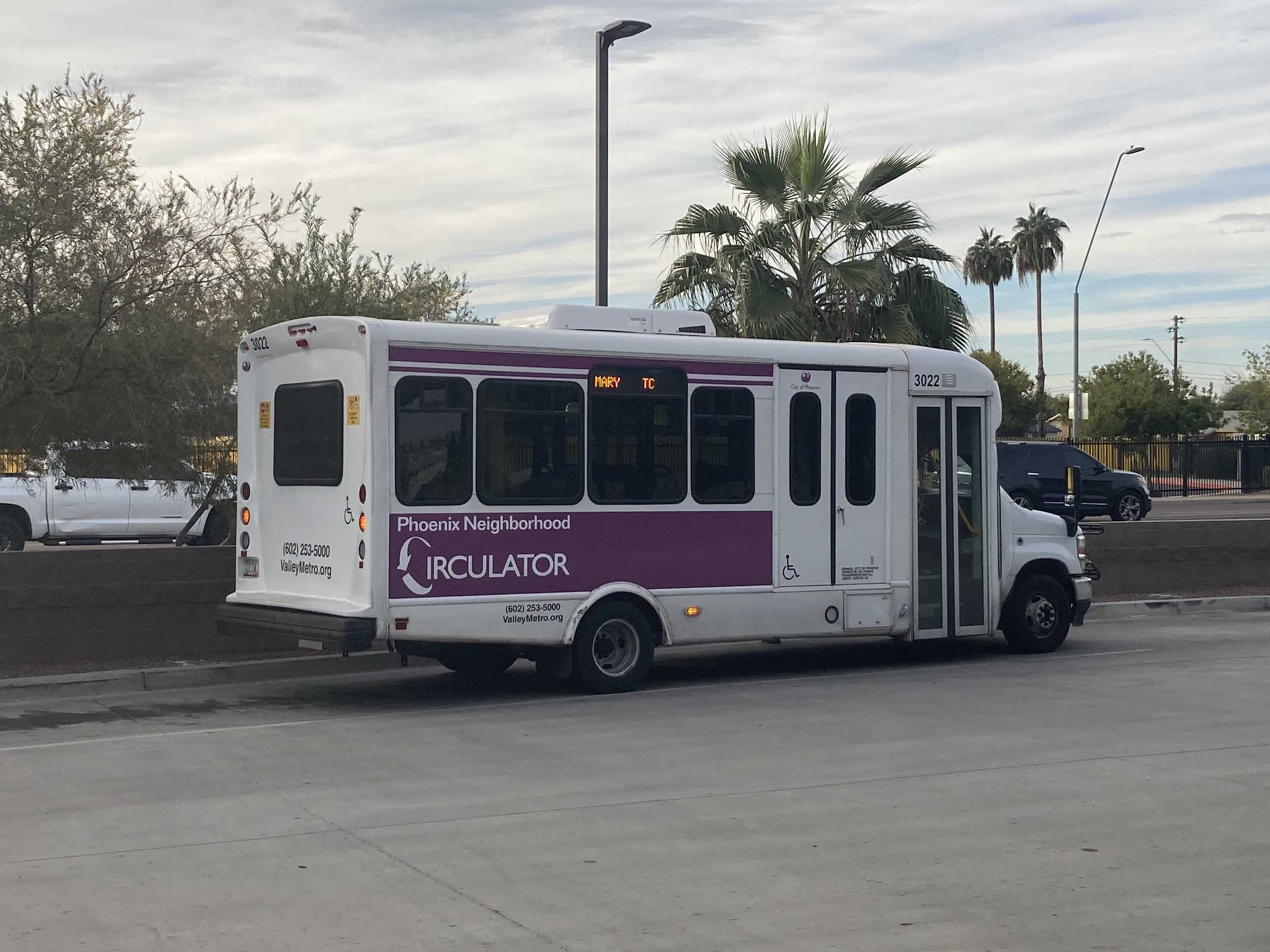 A white and purple Phoenix Neighborhood Circulator minibus, number 3022, at Desert Sky Transit Center in Phoenix on the MARY route to Desert Sky Transit Center