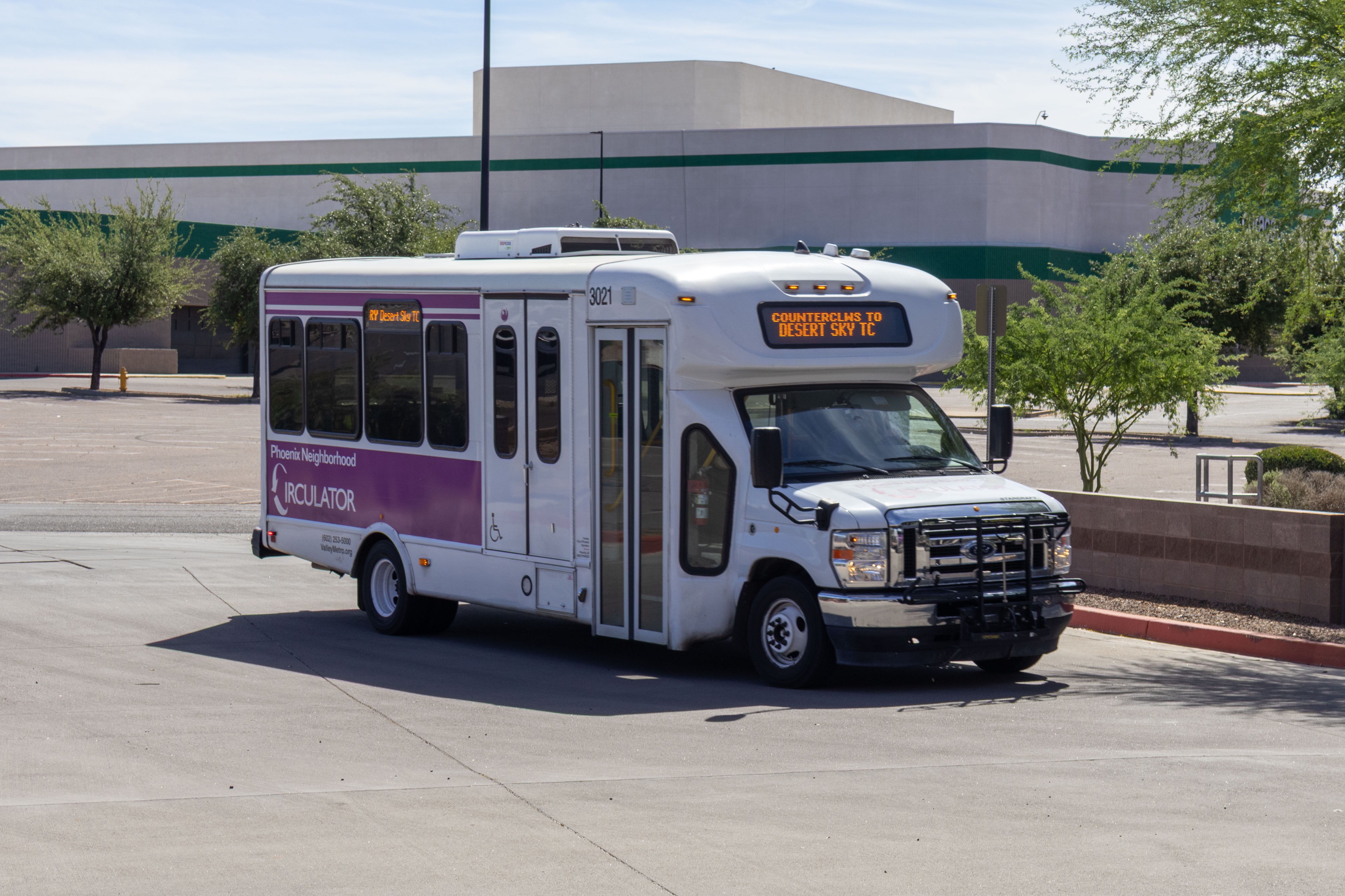A white and purple Phoenix Neighborhood Circulator minibus, number 3021, at Desert Sky Transit Center in Phoenix on the MARY route to Desert Sky Transit Center
