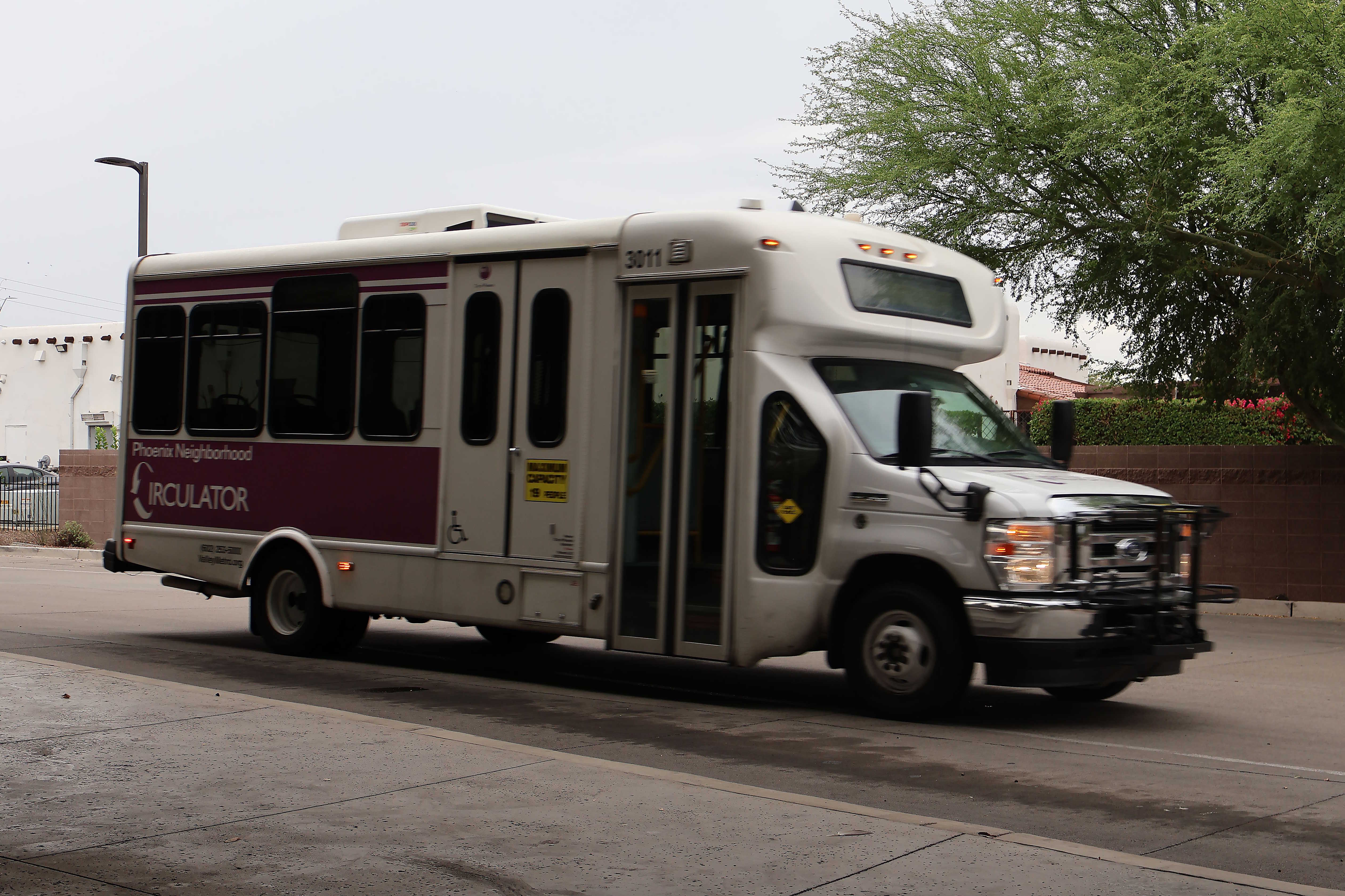 A white and purple Phoenix Neighborhood Circulator minibus, number 3011, at Desert Sky Transit Center in Phoenix on the MARY route to Desert Sky Transit Center