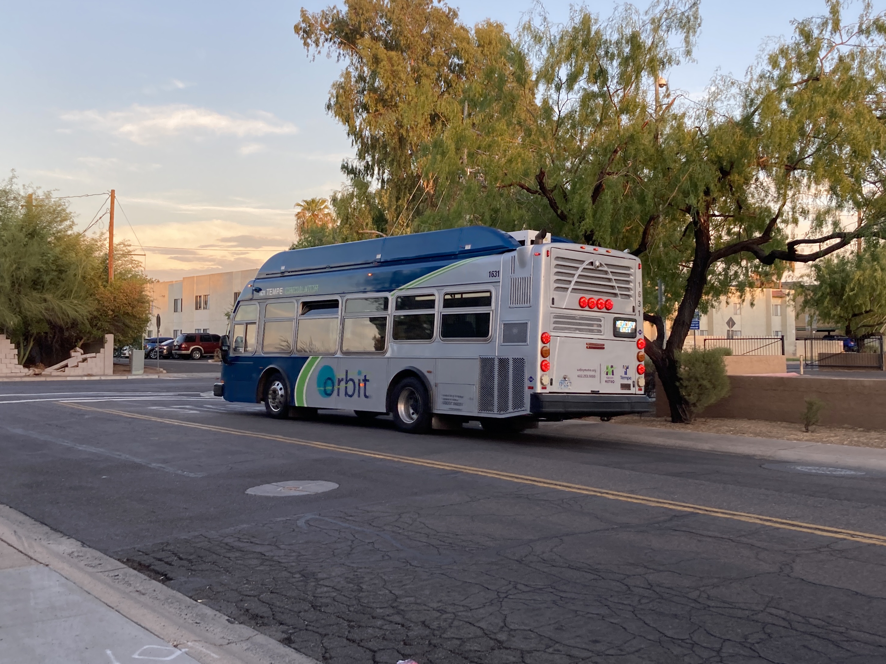 A gray and blue Orbit bus, with a green stripe, number 1631, traveling eastbound on Lemon Street on the Mercury route to Escalante Community Center