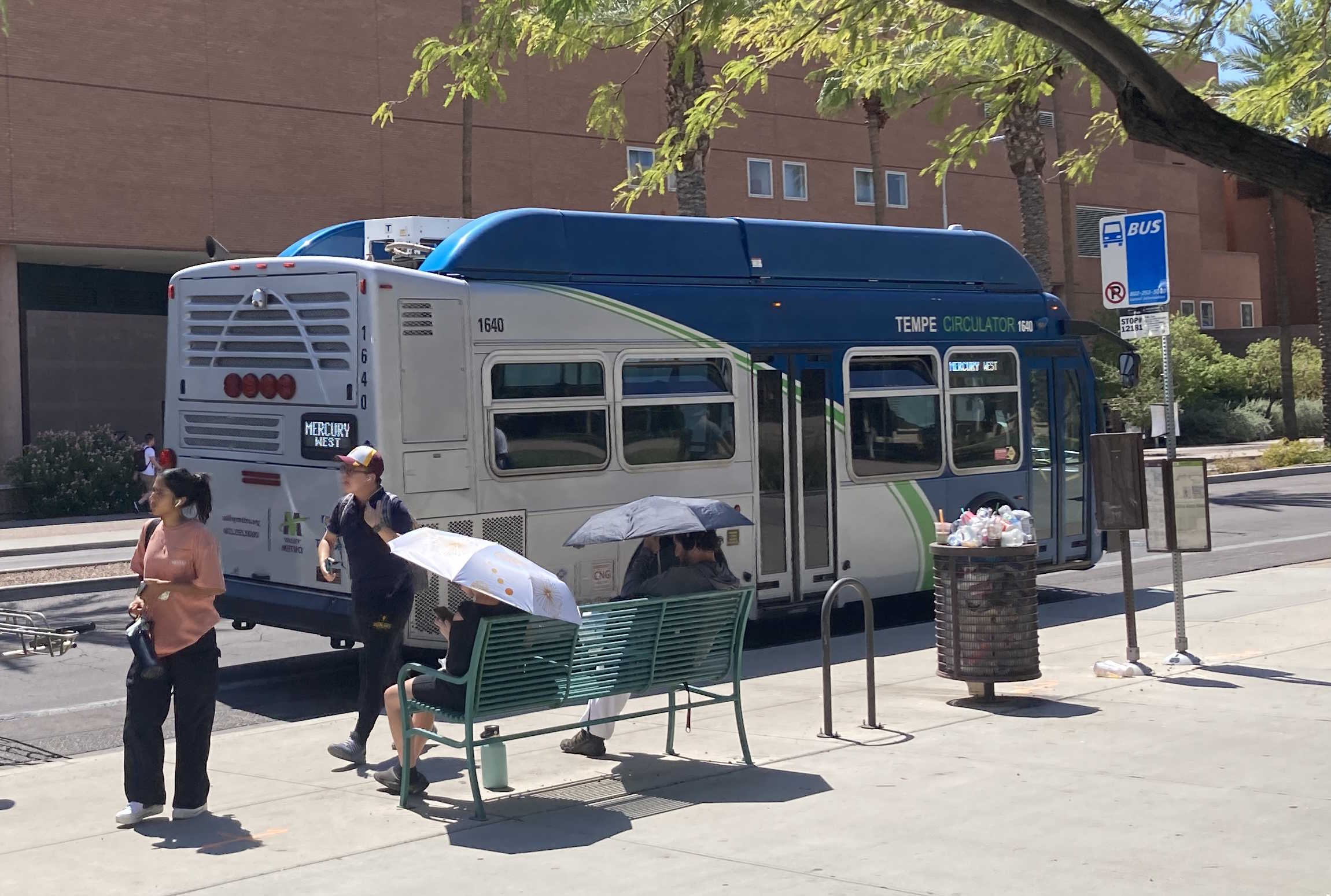 A gray and blue Orbit bus, with a green stripe, number 1640, traveling westbound on University Drive on the Mercury route to Tempe Transportation Center