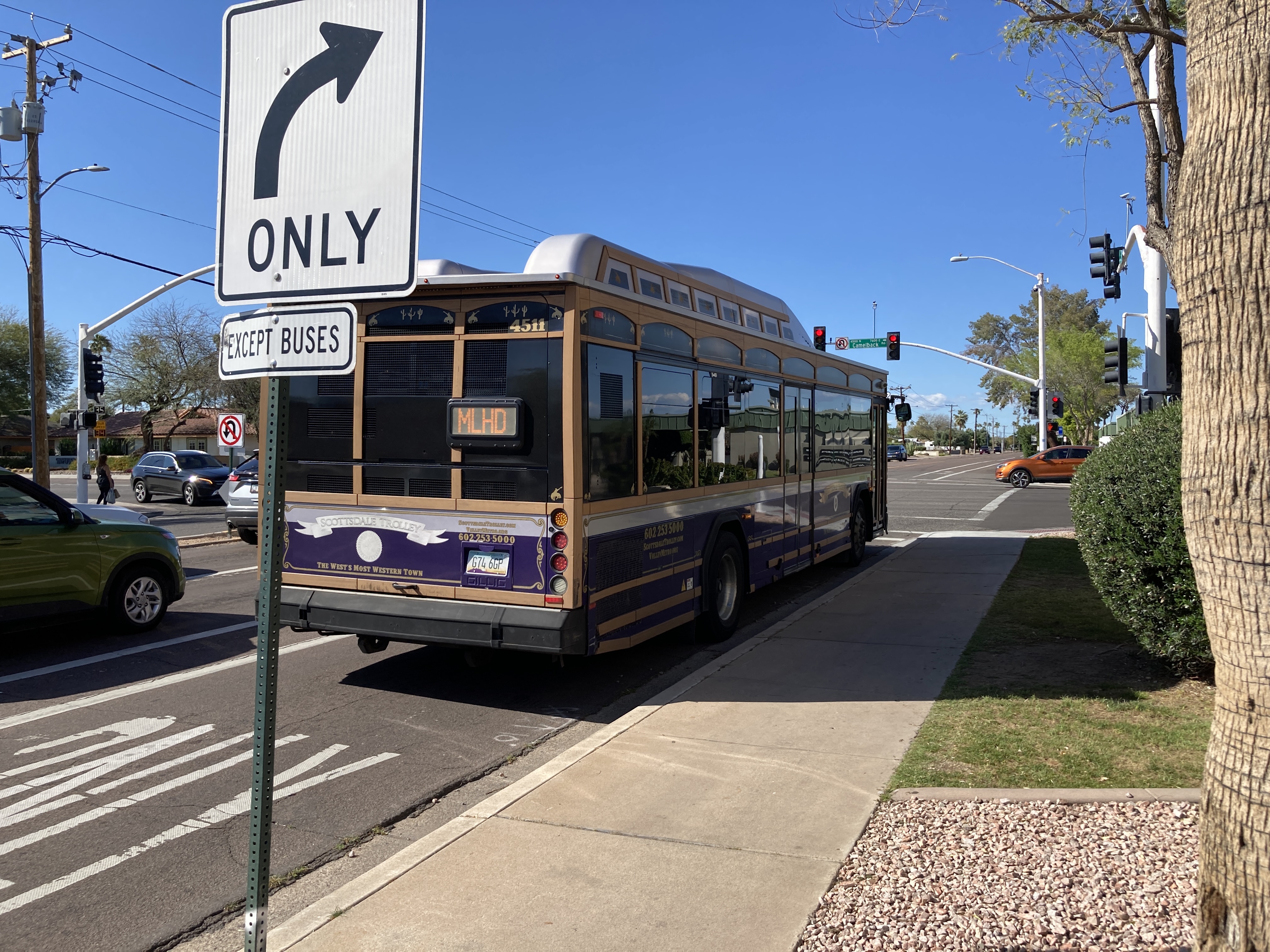 A purple, brown, and silver Scottsdale Trolley bus, number 4511, traveling northbound on Miller Road on the Miller/Hayden Trolley route to Mustang Transit Center