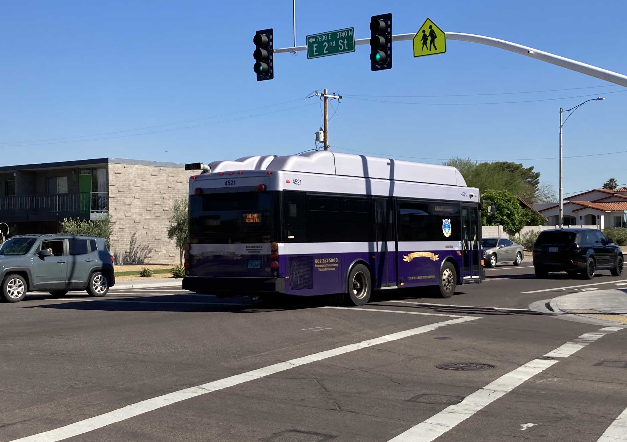 A purple and silver Scottsdale Trolley bus, number 4521, traveling southbound on Miller Road on the Miller/Hayden Trolley route to Granite Reef Senior Center