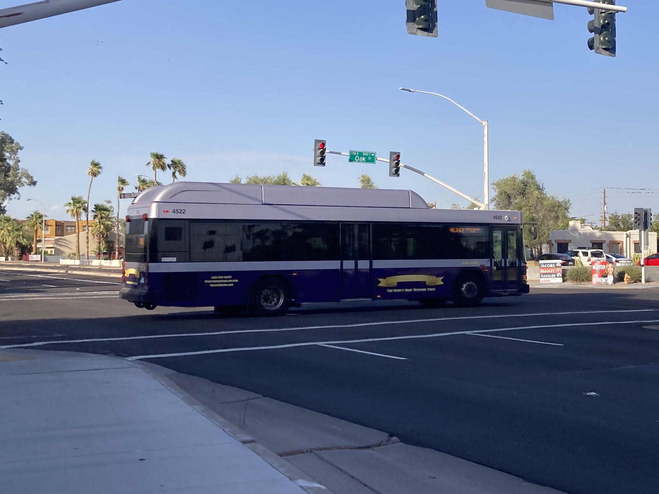 A purple and silver Scottsdale Trolley bus, number 4522, traveling eastbound on Oak Street on the Miller/Hayden Trolley route to Granite Reef Senior Center