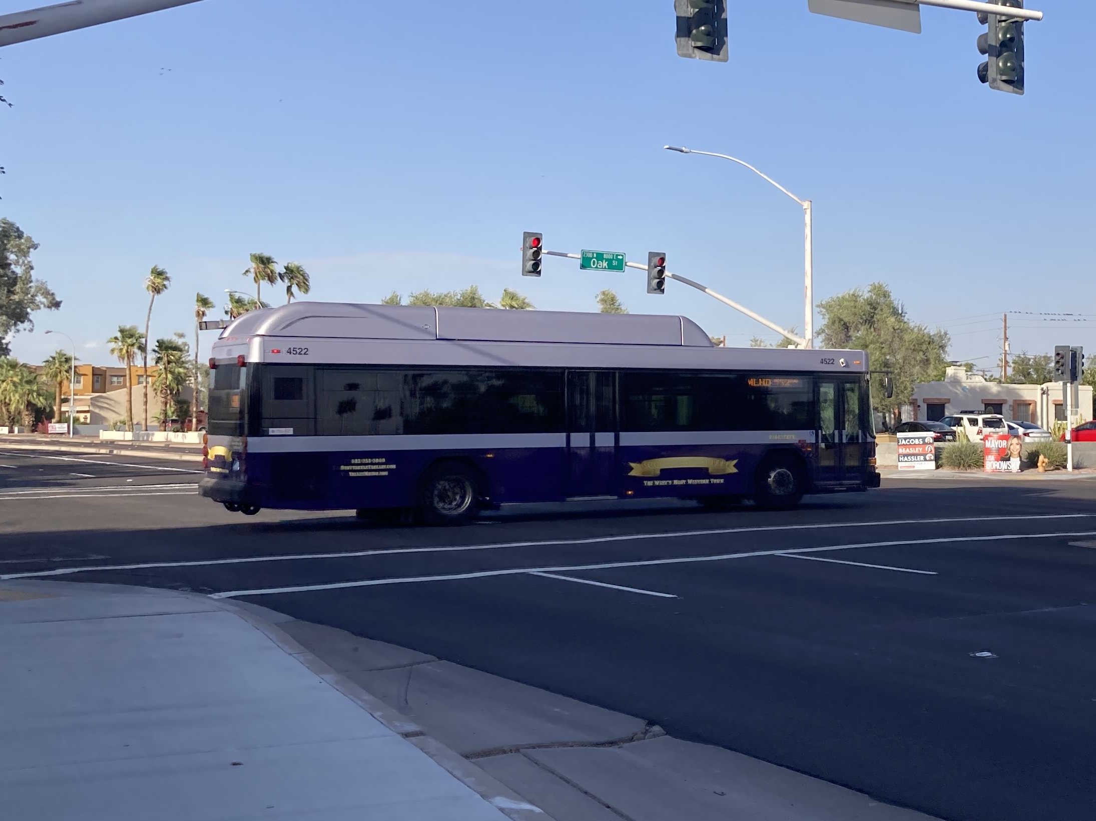 A purple and silver Scottsdale Trolley bus, number 4522, traveling eastbound on Oak Street on the Miller/Hayden Trolley route to Granite Reef Senior Center