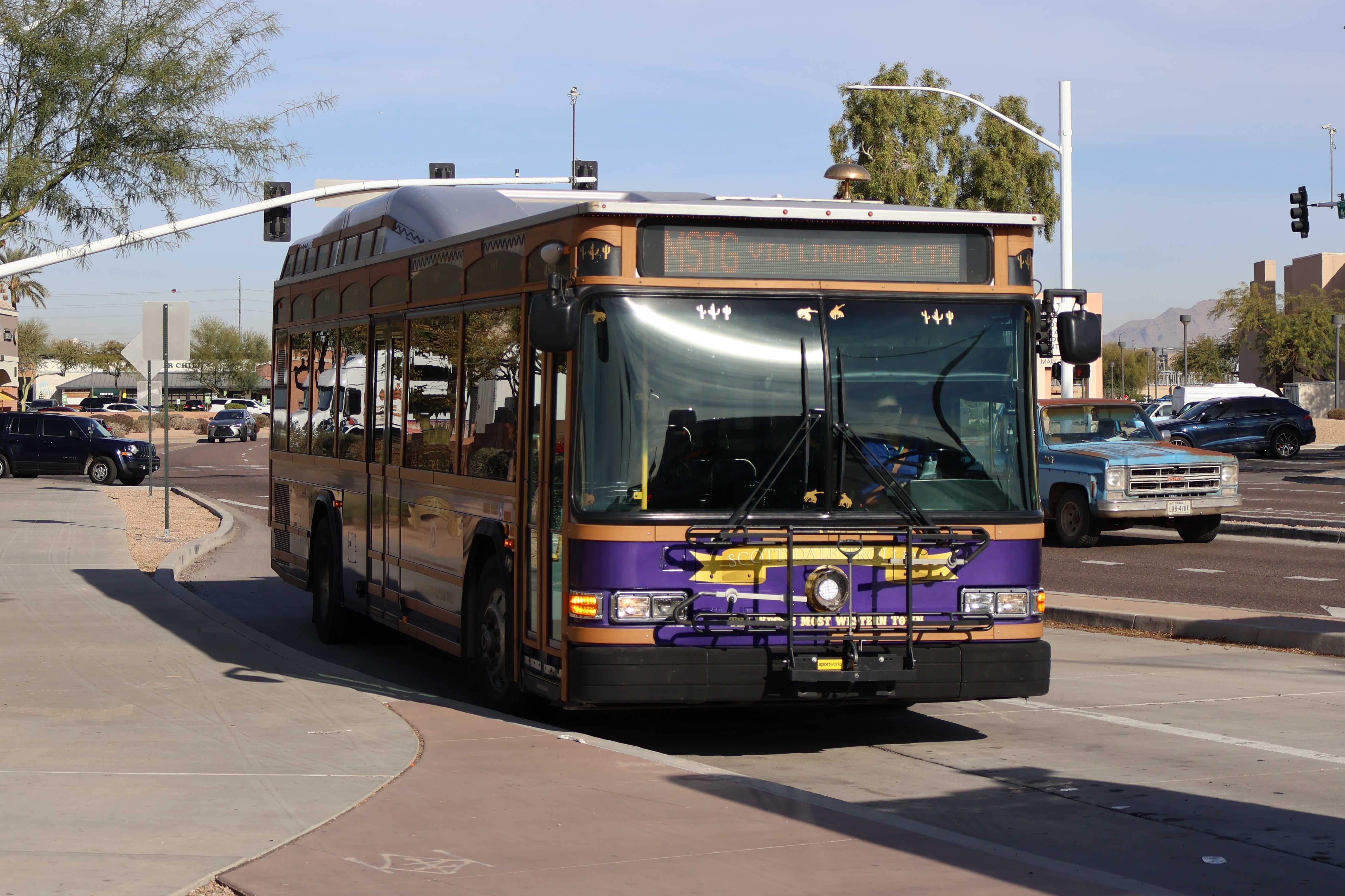 A purple, brown, and silver Scottsdale Trolley bus, number 4512, at Mustang Transit Center on the Mustang Trolley route to Via Linda Senior Center