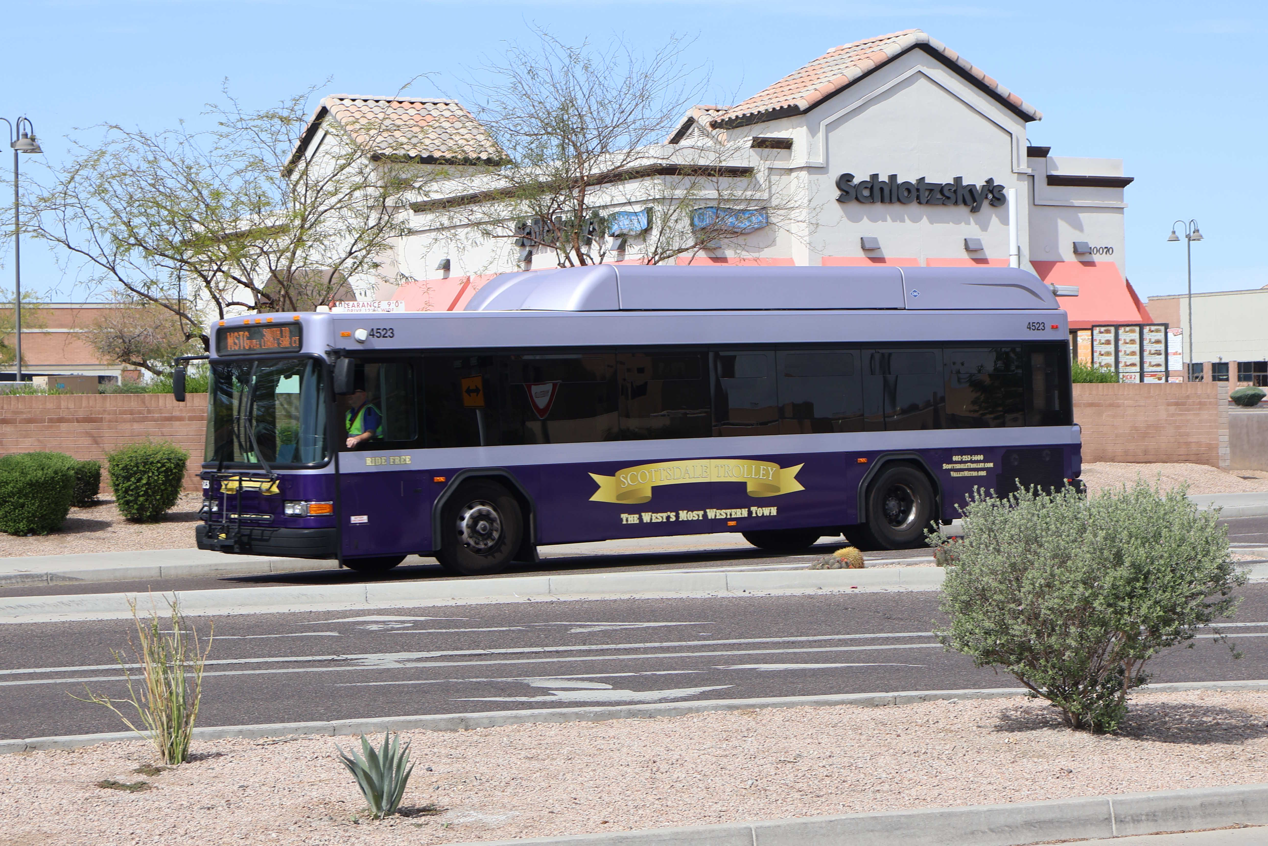 A purple and silver Scottsdale Trolley bus, number 4523, traveling southbound on 90th Street on the Mustang Trolley route to Via Linda Senior Center