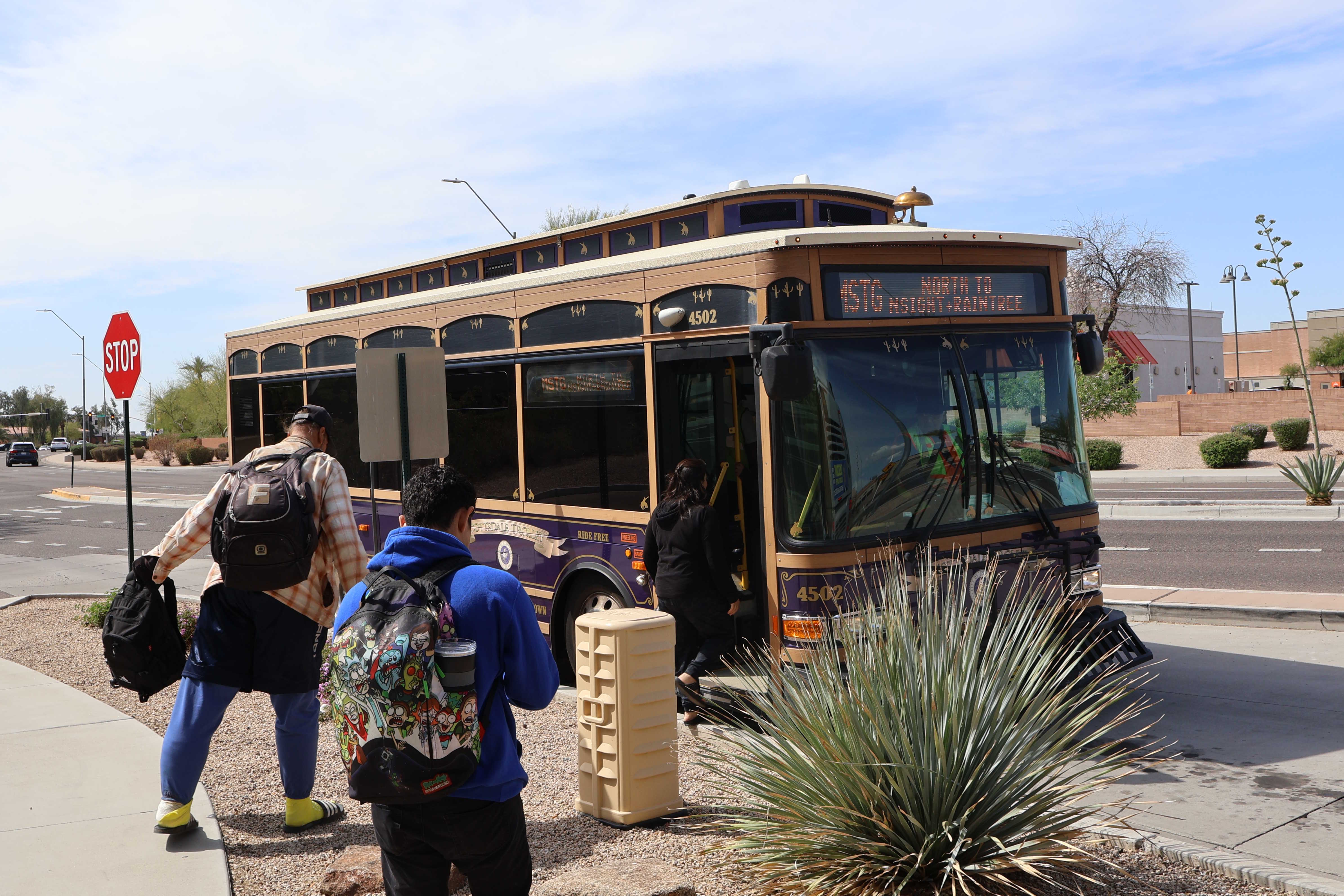 A brown and purple Scottsdale Trolley replica bus, number 4502, at Mustang Transit Center on the Mustang Trolley route to Northsight Boulevard and Raintree Drive
