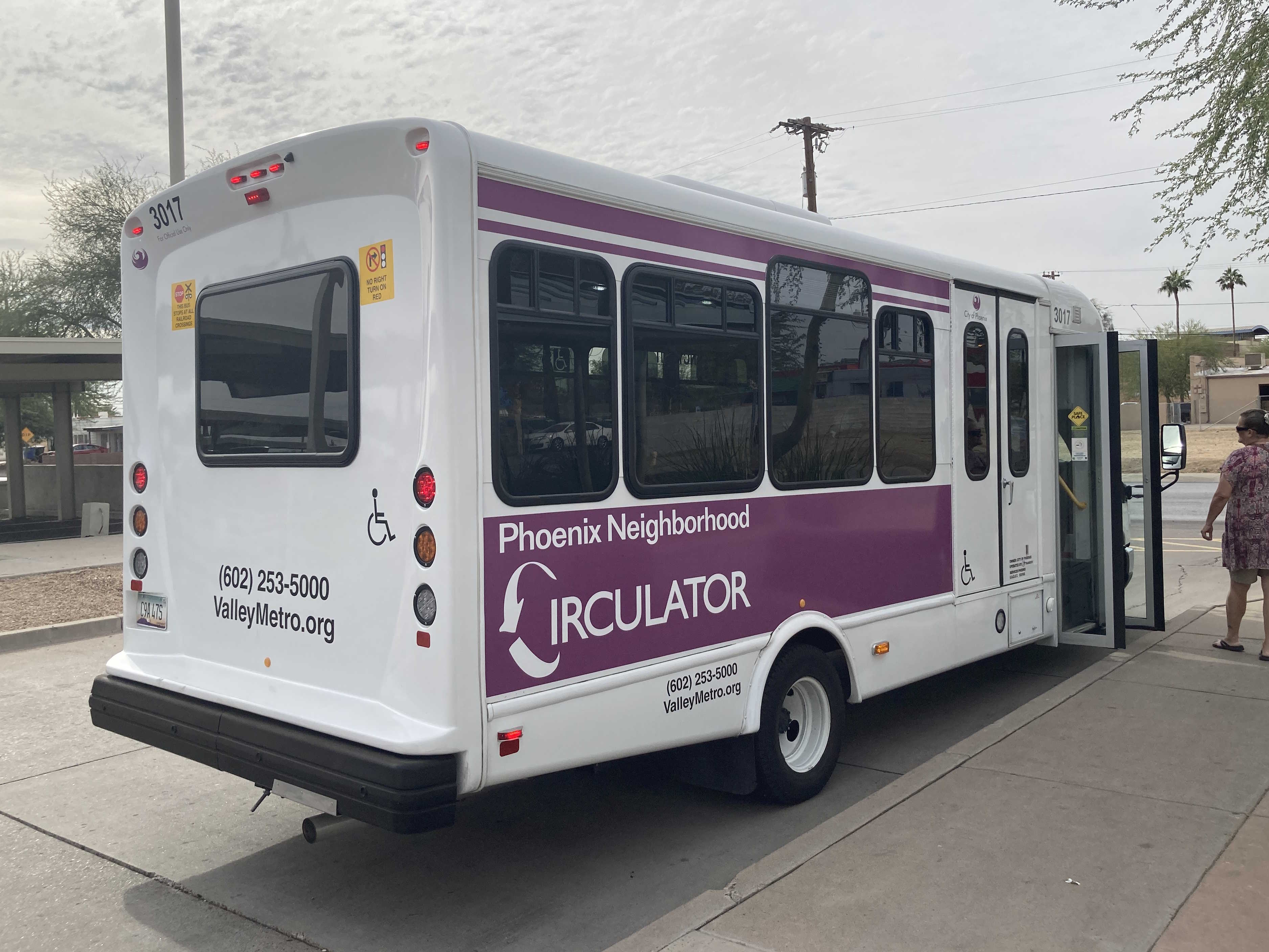 A white and purple Phoenix Neighborhood Circulator minibus, number 3017, at Sunnyslope Transit Center in Phoenix on the SMART route to Cinnabar Avenue and 15th Street