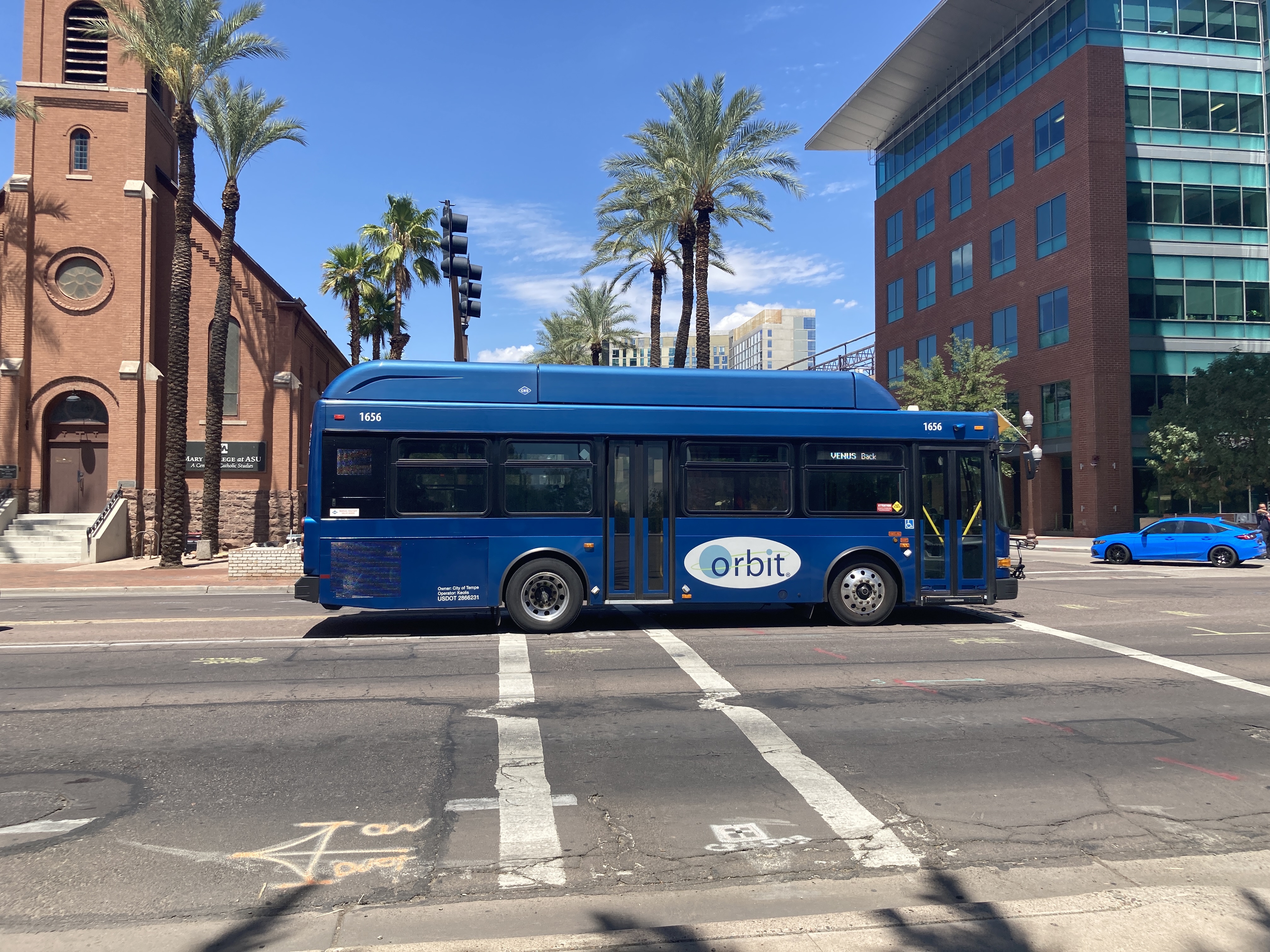 A blue Orbit bus, number 1656, traveling eastbound on University Drive on Venus Back