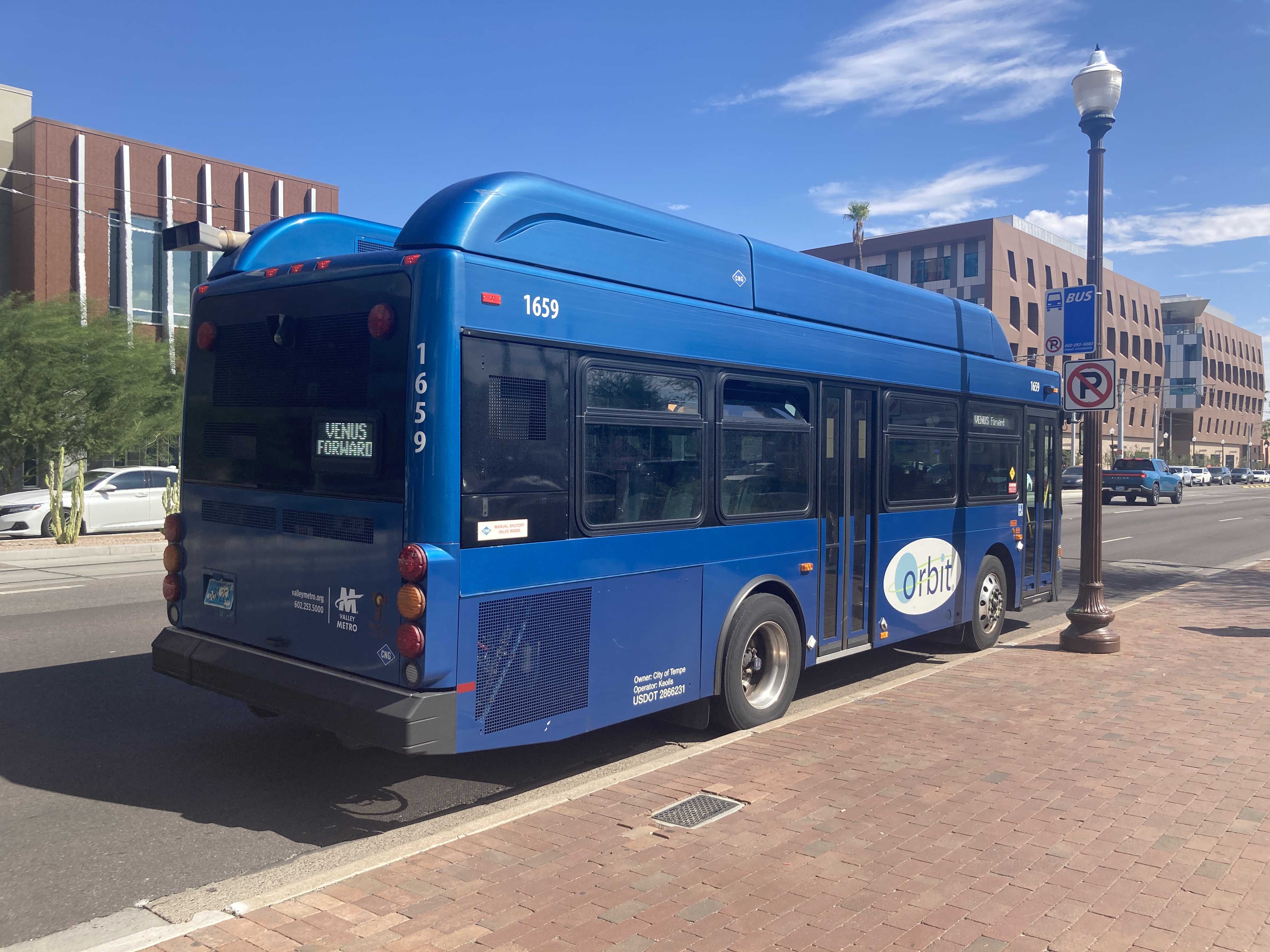 A blue Orbit bus, number 1659, traveling southbound on Mill Avenue on Venus Forward