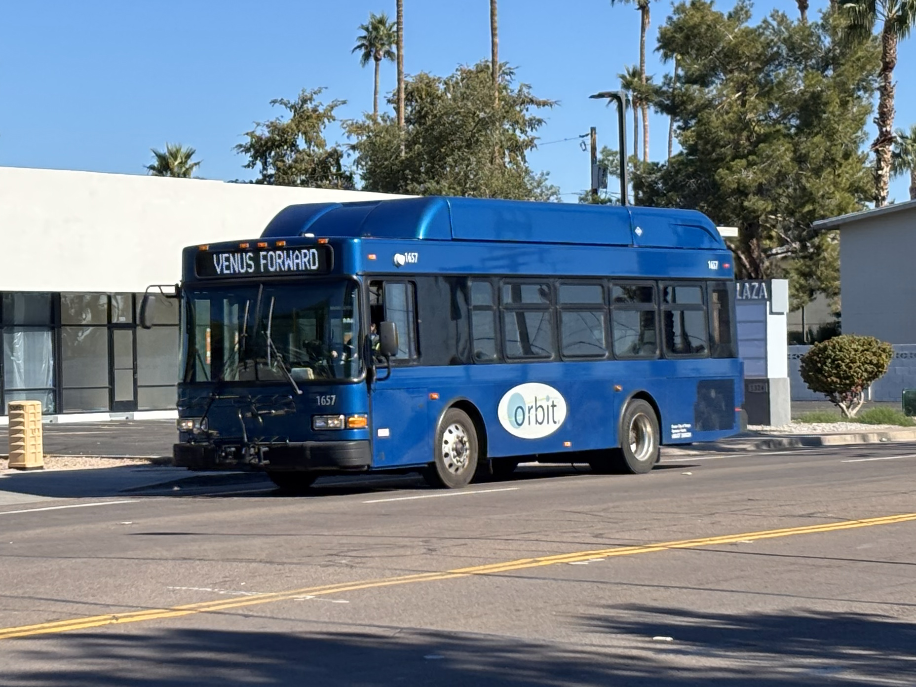 A blue Orbit bus, number 1657, traveling westbound on University Drive on Venus Forward