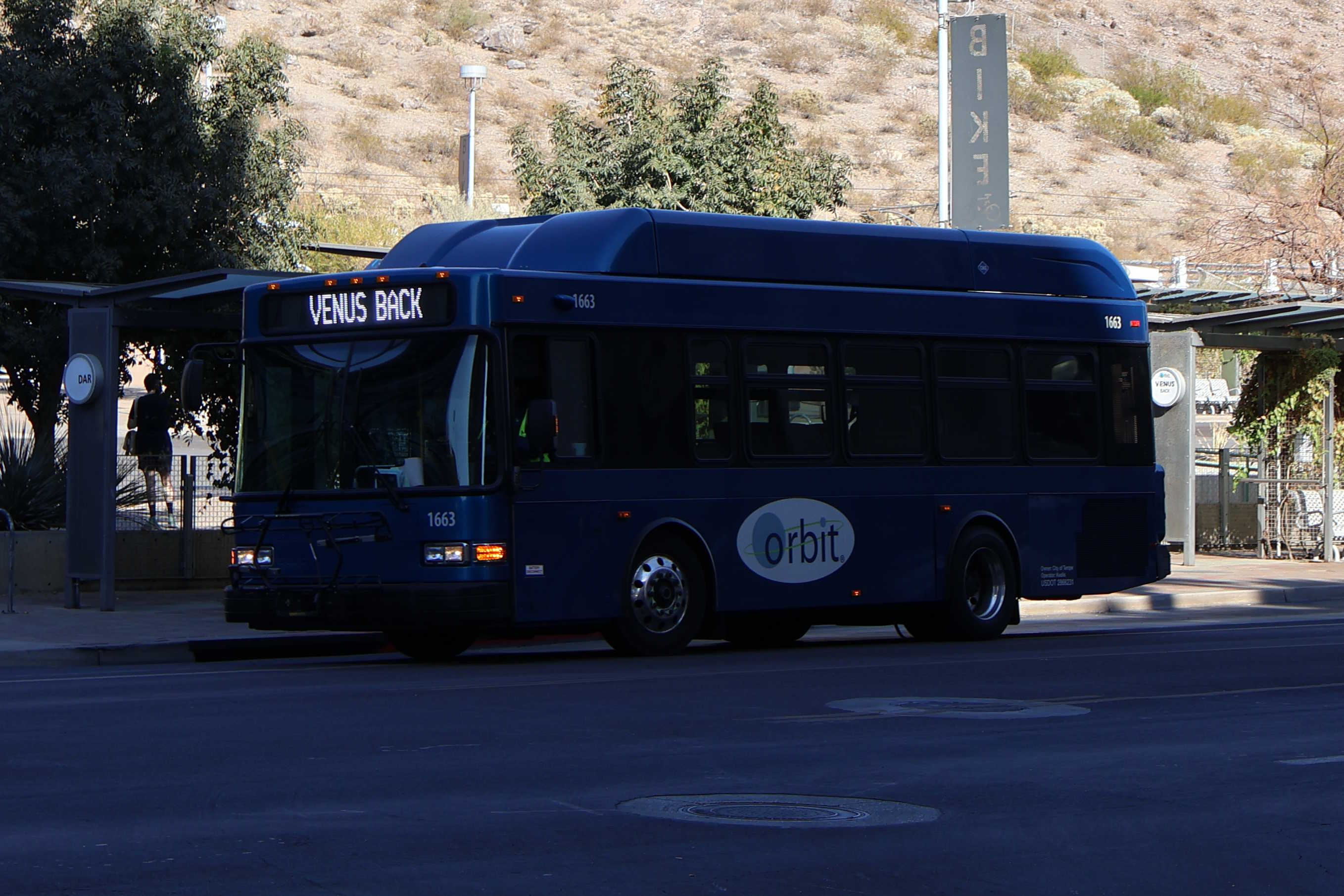 A blue Orbit bus, number 1663, traveling westbound on 5th Street on Venus Back