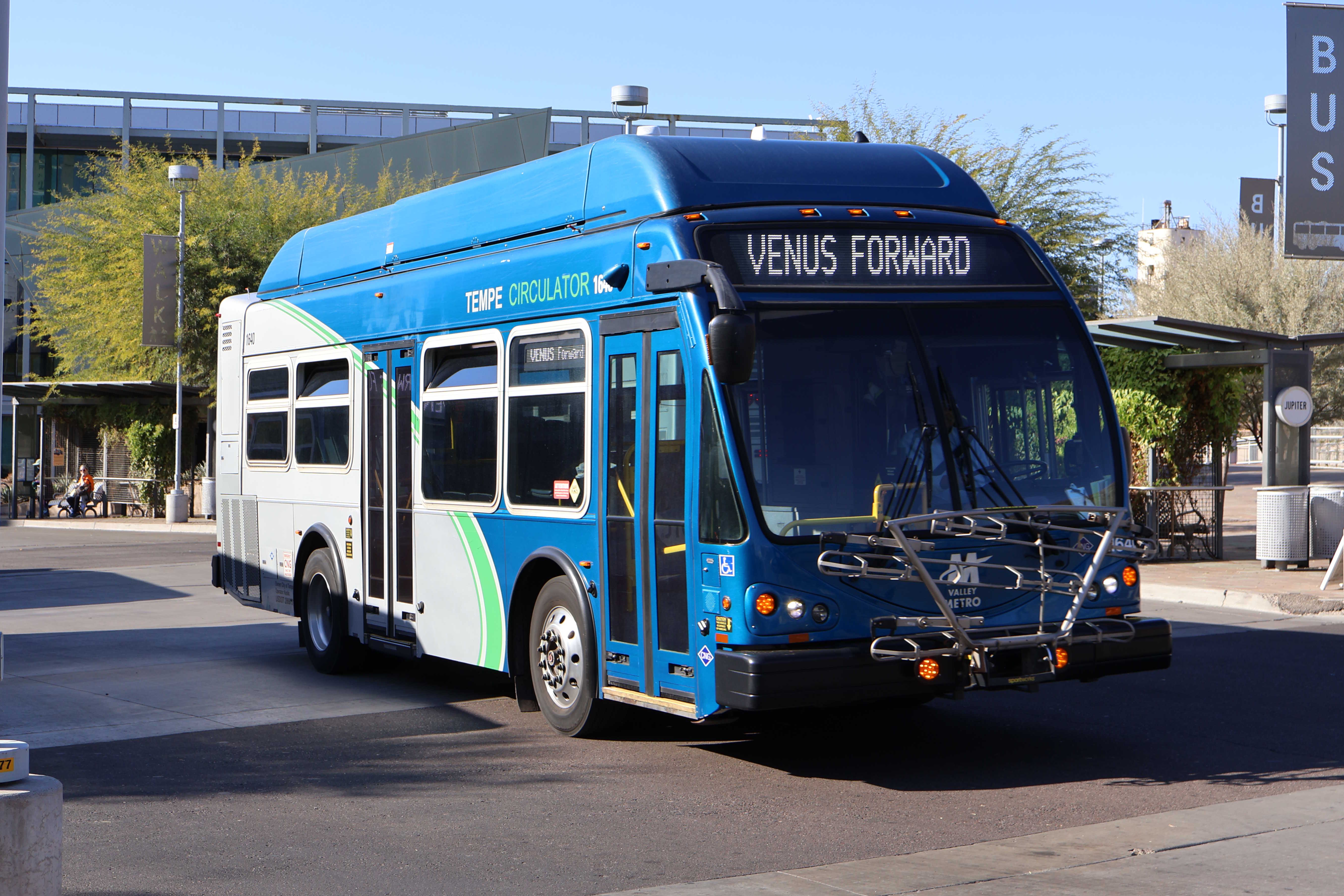 A gray and blue Orbit bus, with a green stripe, number 1640, at Tempe Transportation Center on Venus Forward